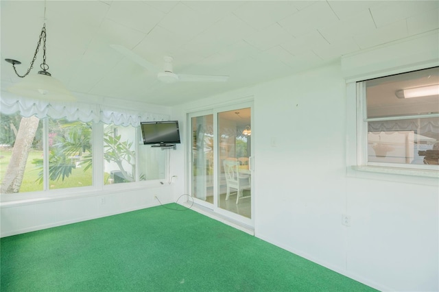 unfurnished sunroom featuring ceiling fan