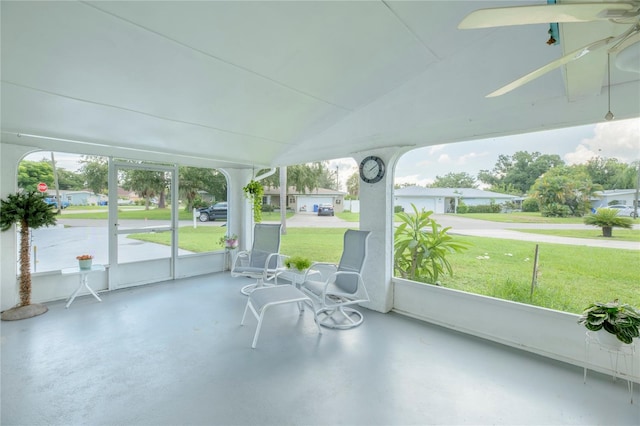 unfurnished sunroom featuring lofted ceiling and ceiling fan