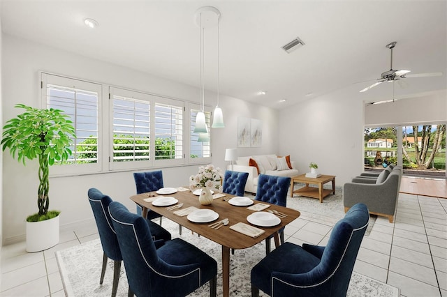 tiled dining room with ceiling fan