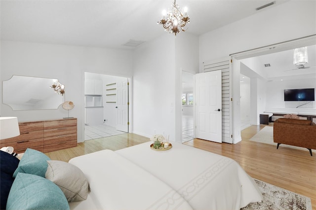 tiled bedroom featuring an inviting chandelier