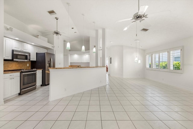 kitchen featuring light tile patterned flooring, white cabinetry, appliances with stainless steel finishes, decorative backsplash, and ceiling fan