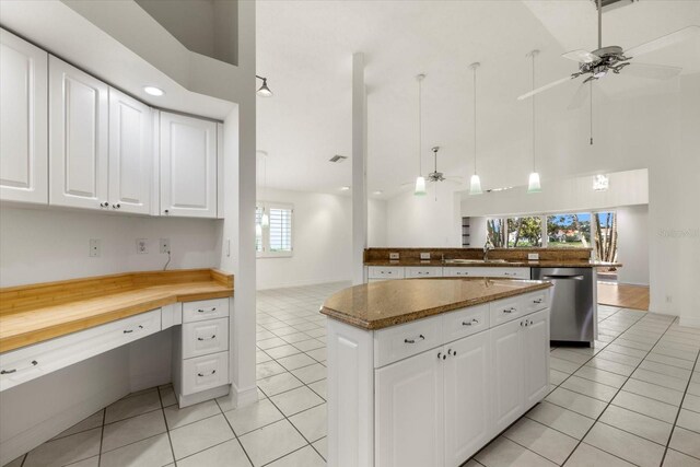 kitchen featuring ceiling fan, high vaulted ceiling, dishwasher, and a kitchen island