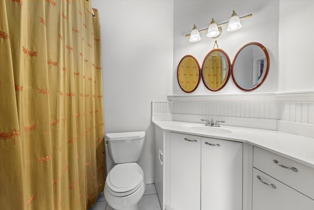 bathroom featuring tile patterned flooring, vanity, and toilet