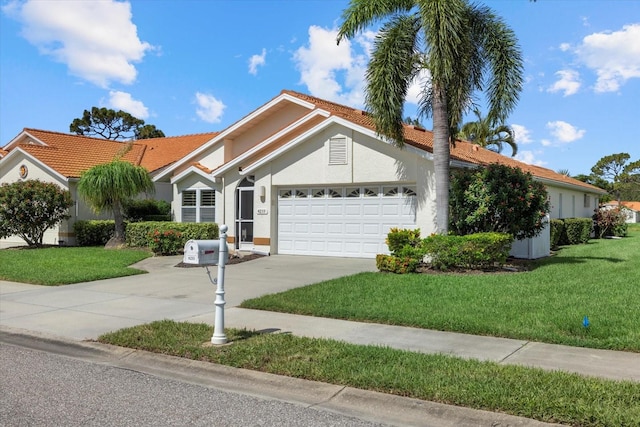 view of front of property with a garage and a front lawn