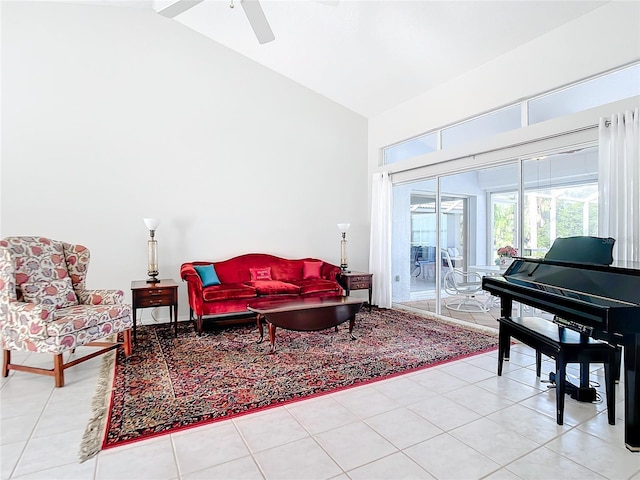 sitting room featuring ceiling fan, vaulted ceiling, and light tile patterned floors