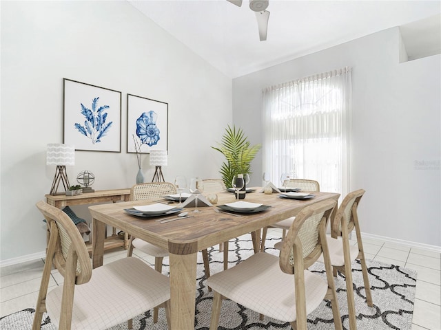 tiled dining area with vaulted ceiling and ceiling fan