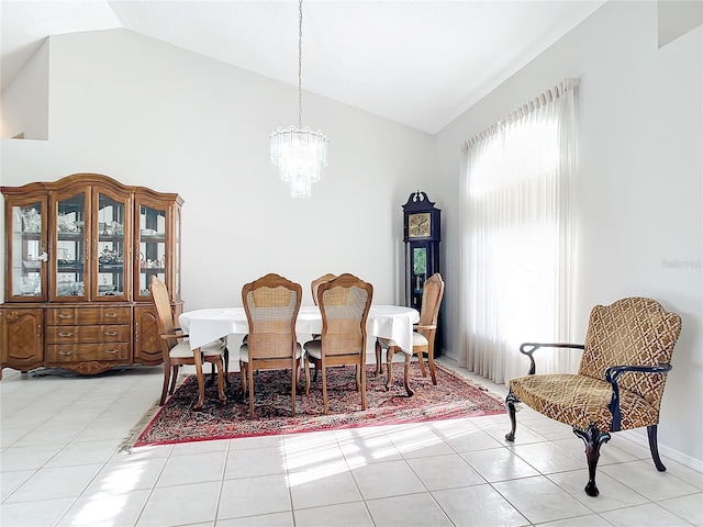 tiled dining room with high vaulted ceiling and an inviting chandelier