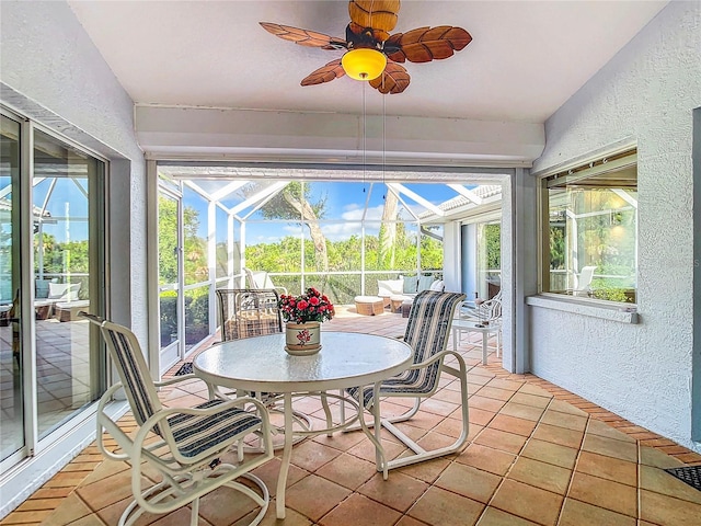 unfurnished sunroom featuring ceiling fan