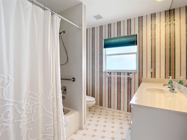 full bathroom featuring vanity, shower / bath combination with curtain, and toilet