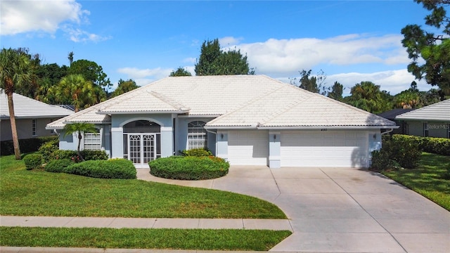 view of front of property featuring a garage and a front yard