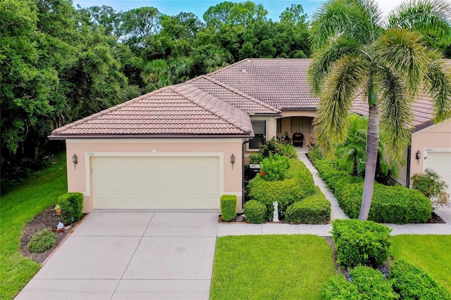 view of front of property with a tile roof, concrete driveway, and stucco siding