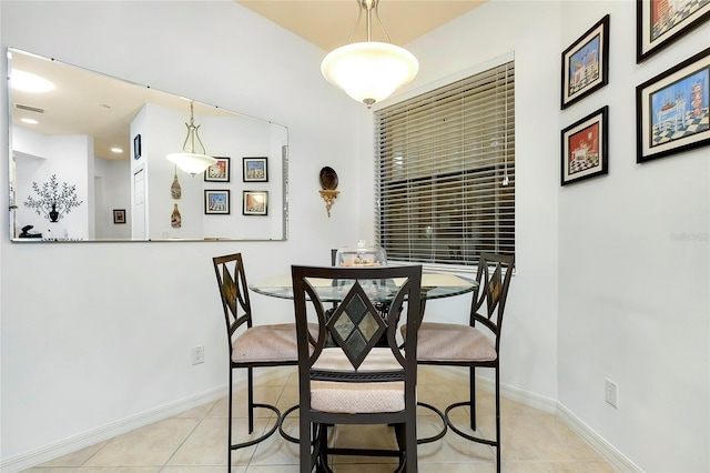 dining space with light tile patterned floors and baseboards