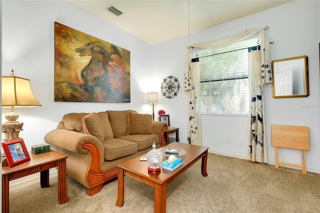 living area featuring light carpet, visible vents, and baseboards