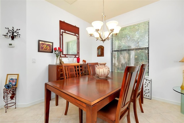 dining room featuring baseboards, an inviting chandelier, and light tile patterned floors