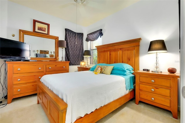 bedroom with a ceiling fan and light colored carpet