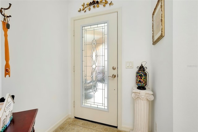 doorway to outside featuring baseboards