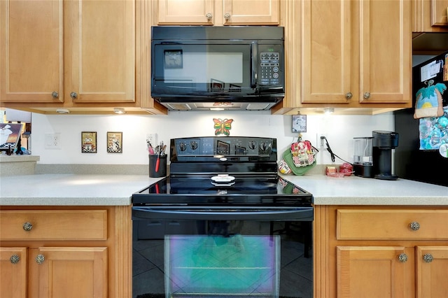 kitchen with light countertops and black appliances