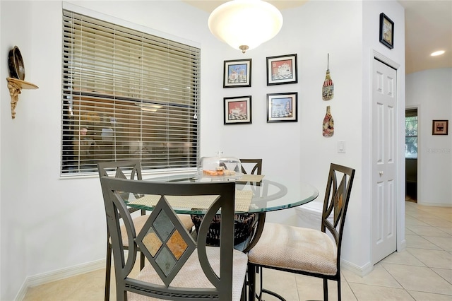 dining room with light tile patterned floors, baseboards, and recessed lighting