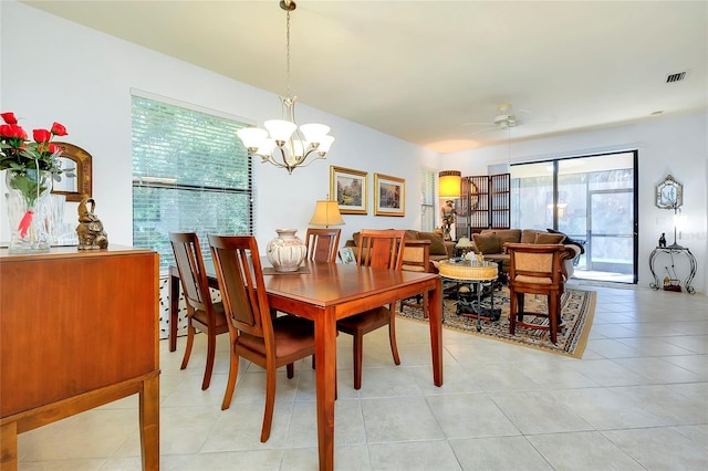 dining room featuring ceiling fan with notable chandelier, light tile patterned floors, and visible vents