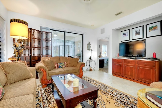 living area featuring light tile patterned floors and visible vents