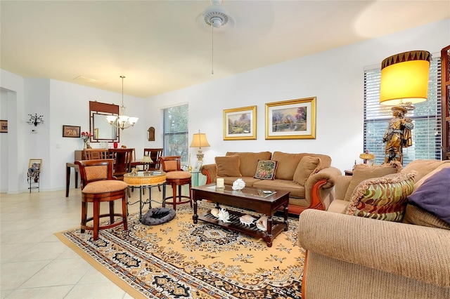 living room with light tile patterned flooring and an inviting chandelier