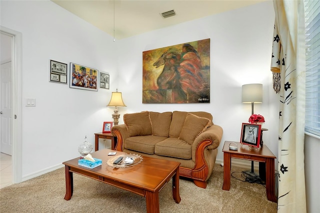 living area with light carpet, baseboards, and visible vents