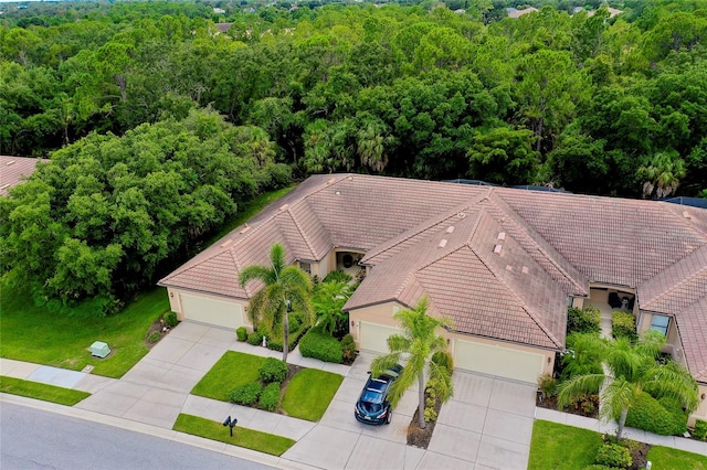 birds eye view of property with a forest view