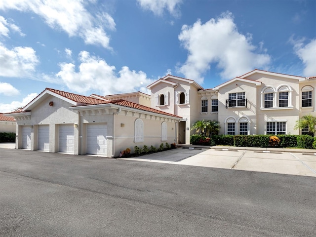 mediterranean / spanish home featuring a garage