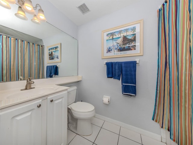 bathroom with tile patterned floors, vanity, and toilet