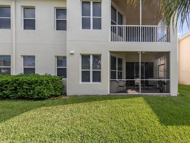 rear view of house with a patio and a lawn