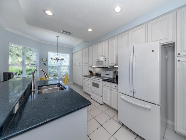 kitchen featuring white appliances, an inviting chandelier, white cabinets, sink, and decorative light fixtures