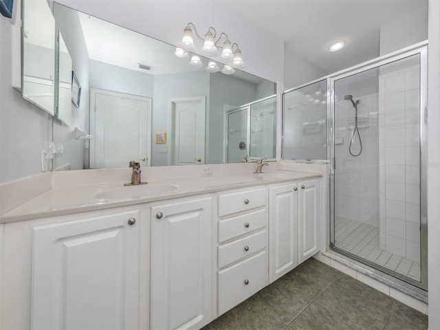 bathroom featuring tile patterned flooring, vanity, and a shower with shower door