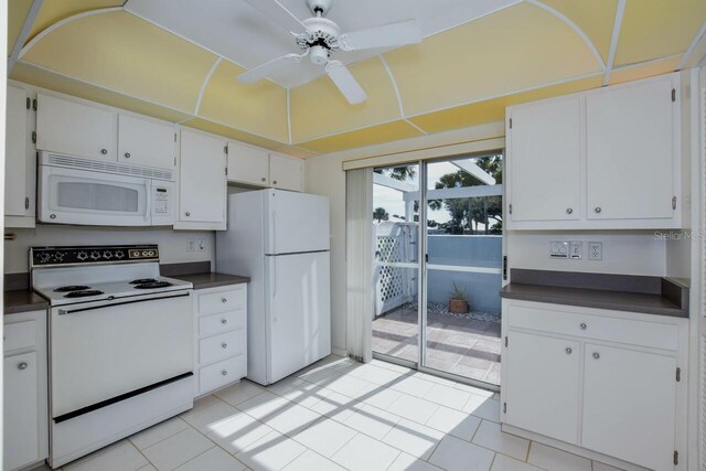 kitchen featuring white cabinetry, ceiling fan, white appliances, and light tile patterned floors