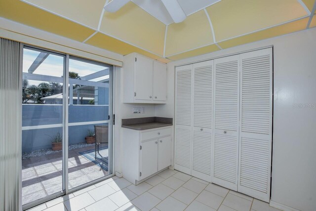 kitchen with light tile patterned floors and white cabinets