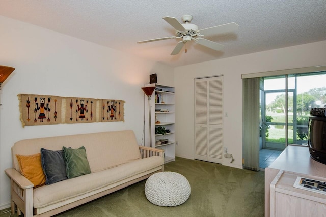 living room featuring a textured ceiling, ceiling fan, and carpet flooring