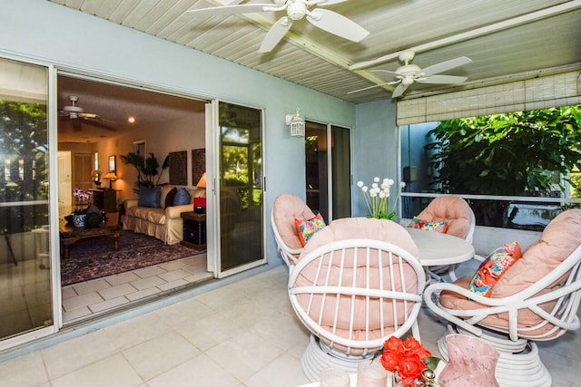 sunroom featuring ceiling fan