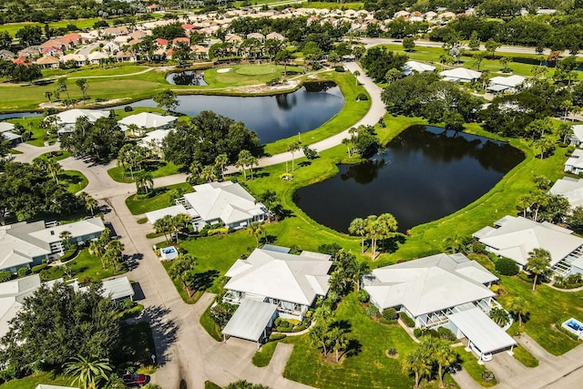 birds eye view of property featuring golf course view, a water view, and a residential view