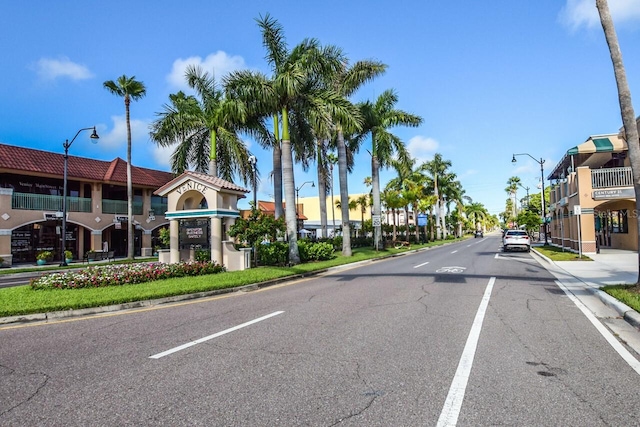 view of street with sidewalks, street lighting, and curbs