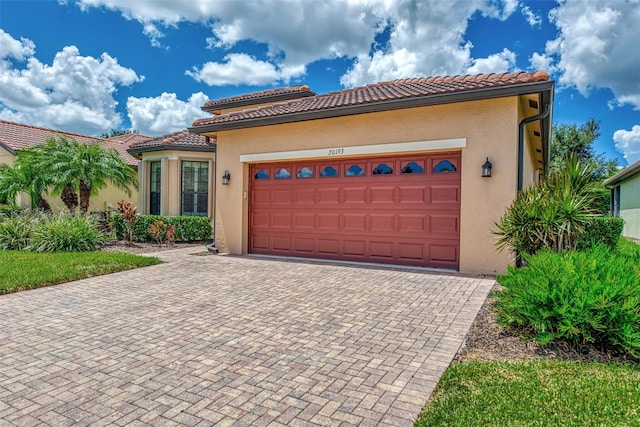 mediterranean / spanish house with a garage