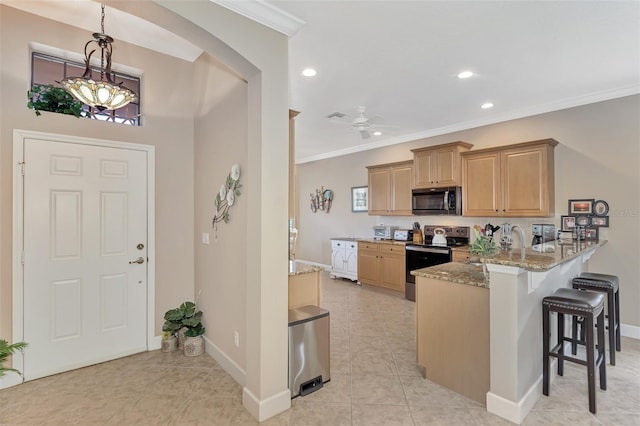 kitchen featuring appliances with stainless steel finishes, ceiling fan, light tile patterned flooring, ornamental molding, and light stone counters