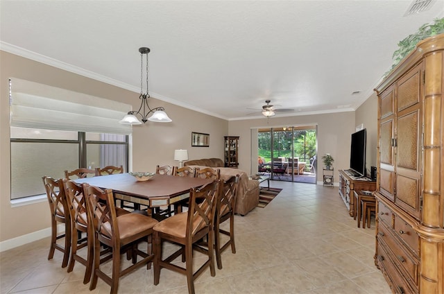 dining room with ceiling fan with notable chandelier, light tile patterned floors, and crown molding