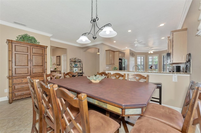 dining area featuring visible vents, ornamental molding, arched walkways, and light tile patterned flooring