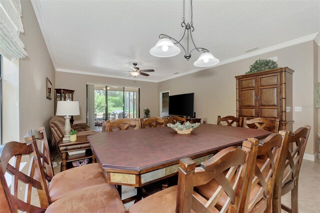 dining area featuring ceiling fan, light tile patterned flooring, a textured ceiling, and ornamental molding