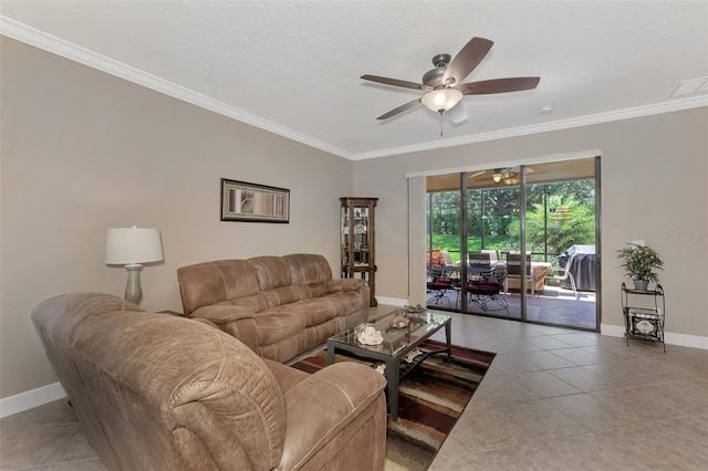 living room featuring ornamental molding, tile patterned flooring, ceiling fan, and baseboards