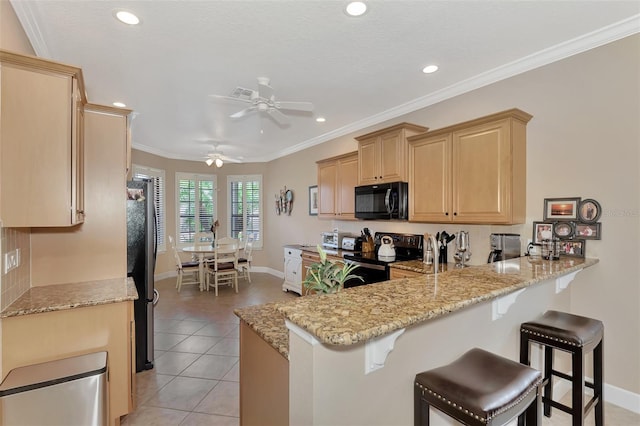 kitchen featuring light brown cabinets, ceiling fan, kitchen peninsula, range with electric cooktop, and fridge