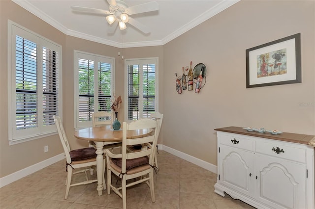 dining space featuring light tile patterned floors, ceiling fan, baseboards, and crown molding