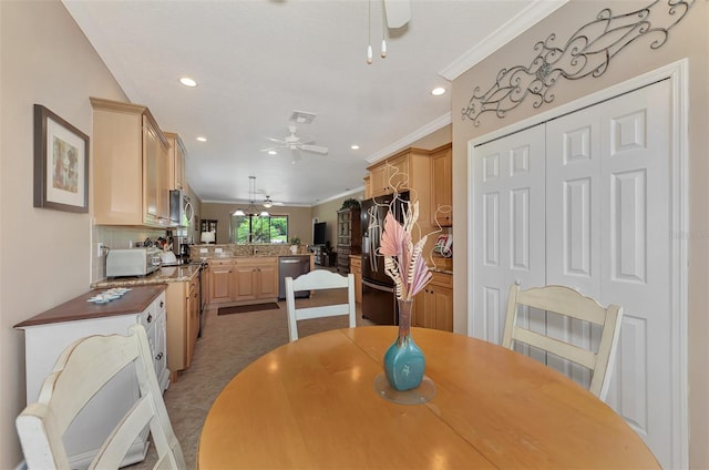 tiled dining area with ceiling fan and crown molding