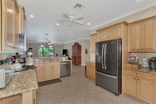 kitchen with decorative light fixtures, visible vents, appliances with stainless steel finishes, a sink, and light stone countertops