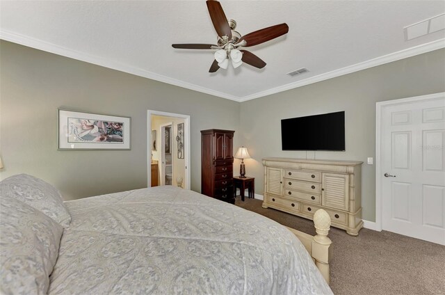 bedroom featuring ceiling fan, ensuite bathroom, ornamental molding, and carpet