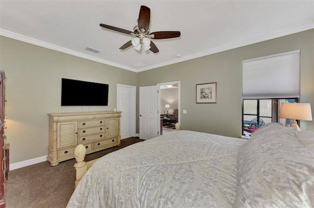 bedroom with ornamental molding, dark carpet, visible vents, and baseboards